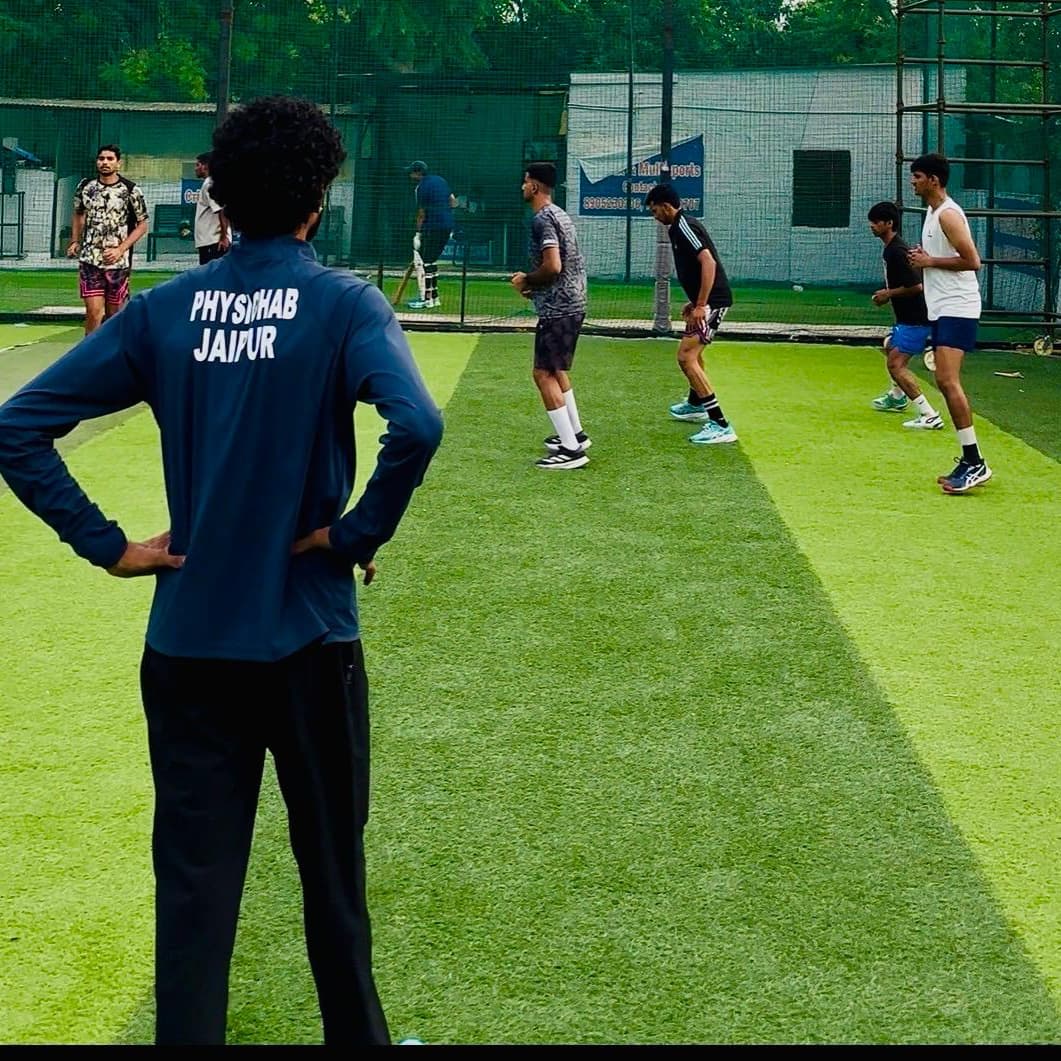 ACL PhysioHab Jaipur physiotherapist supervising an outdoor sprint and agility session on a turf field